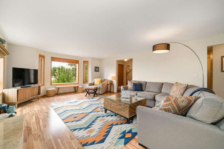 Main floor living room with fireplace, ocean view, Roku w/live TV, DVD player, books, games. 