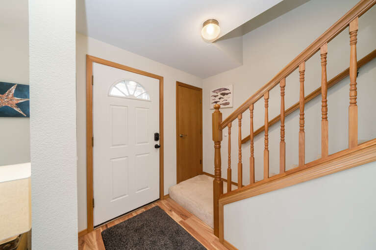 Stairs to upper floor with 3 bedrooms and a full bath. 