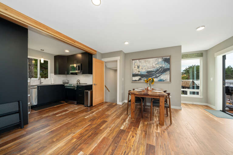 Dining room open to living room and kitchen with access to upper deck. Extra Table and chairs for dining in front closet. 