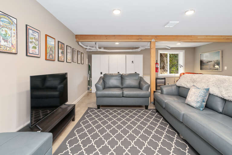 Downstairs family room with Queen sleeper sofa, ping pong, streaming TV, games, regulation dart board, mini fridge, wine cooler, access to back yard. 