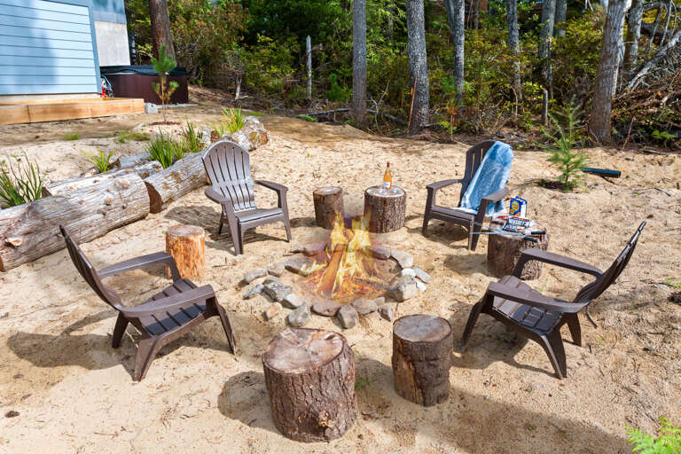Back yard with hot tub and outdoor firepit. 