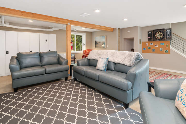 Downstairs family room with Queen sleeper sofa, ping pong, streaming TV, games, regulation dart board, mini fridge, wine cooler, access to back yard.  