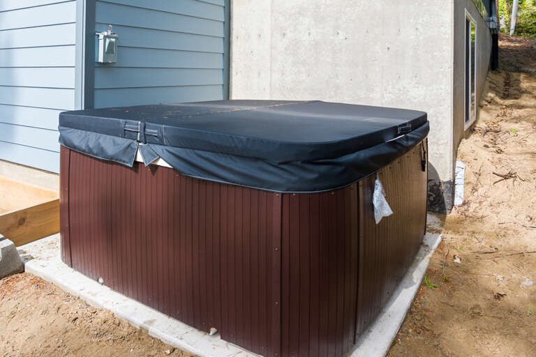 Back yard with hot tub and outdoor firepit. 