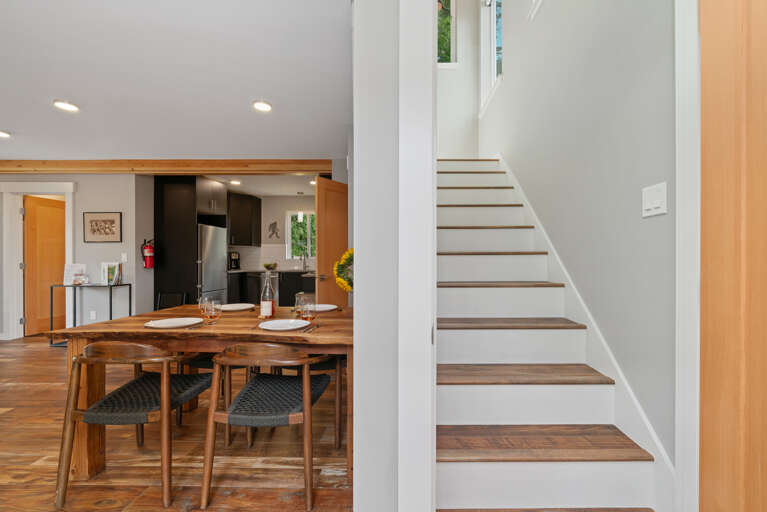 Stairs to the upper family suite bedroom with Queen and double bunk beds.