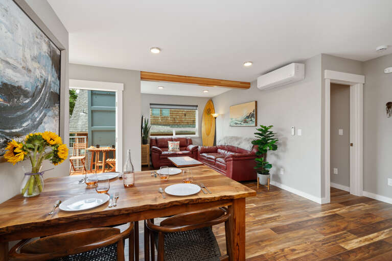 Dining room open to living room and kitchen with access to upper deck. Extra Table and chairs for dining in front closet. 