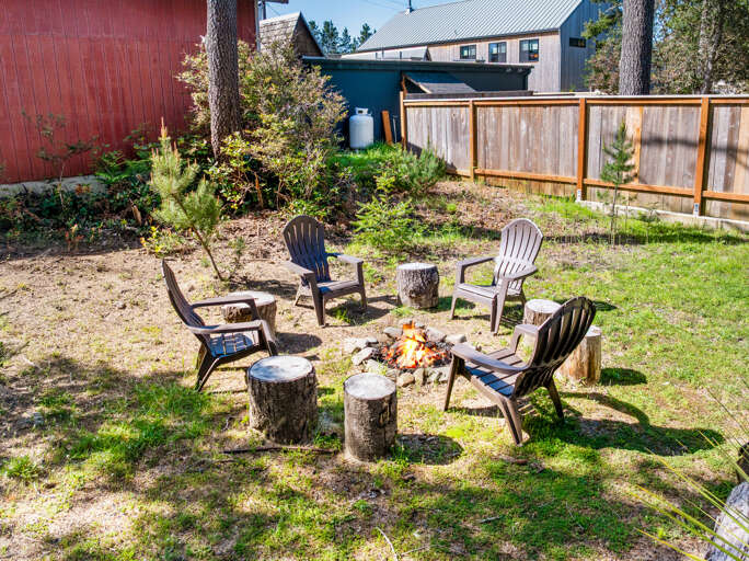 Backyard with firepit area and private hot tub. 