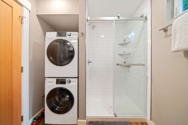 Main floor bath with walk in shower, stackable washer/dryer. 