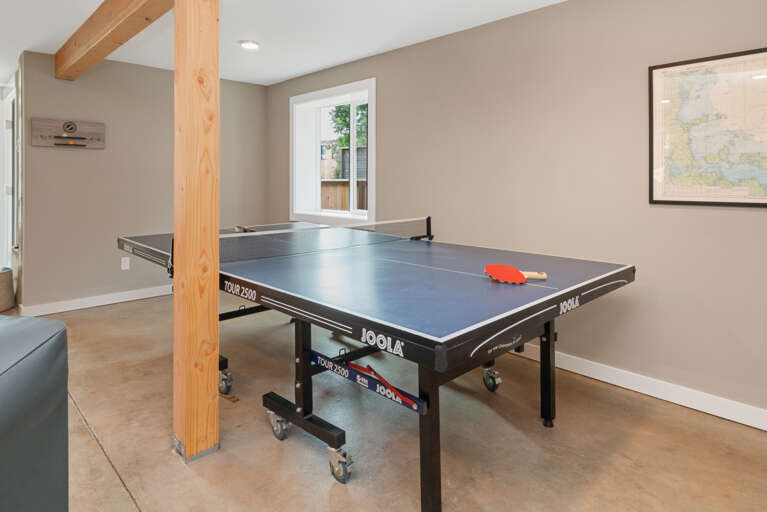 Downstairs family room with Queen sleeper sofa, ping pong, streaming TV, games, regulation dart board, mini fridge, wine cooler, access to back yard. 