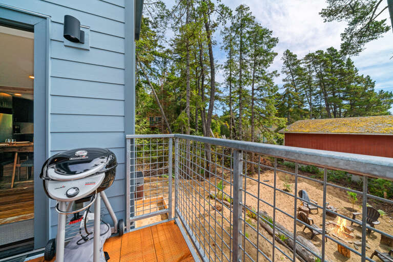 Upper deck that overlooks the back yard with breakfast table, electric BBQ.