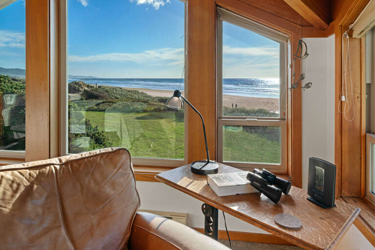 Master bedroom with expansive views, working desk and lounge chair. 