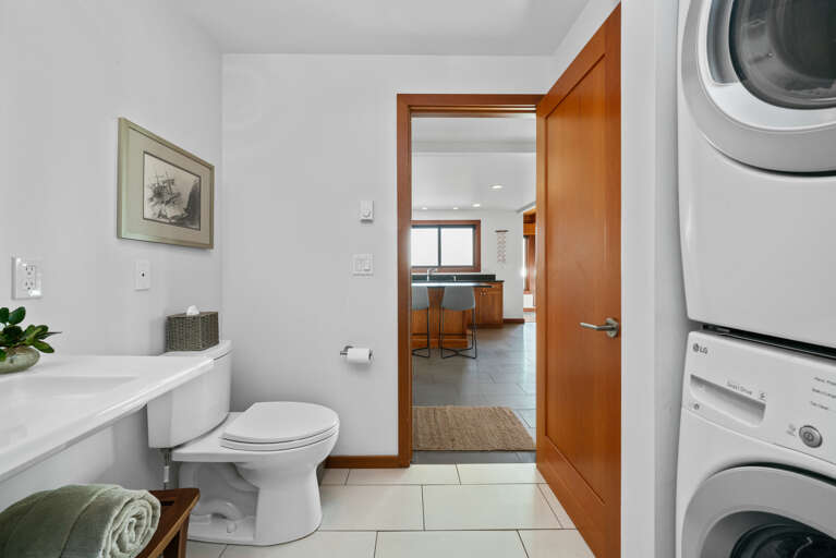 Downstairs full bath with walk in shower with stackable washer/dryer