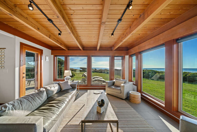 Open living area with smart TV, dining and kitchen area with ocean views.