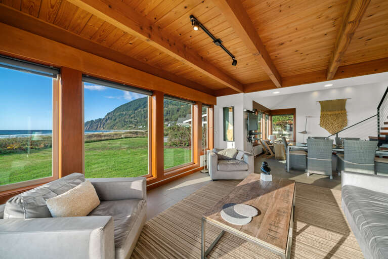 Open living area with smart TV, dining and kitchen area with ocean views.