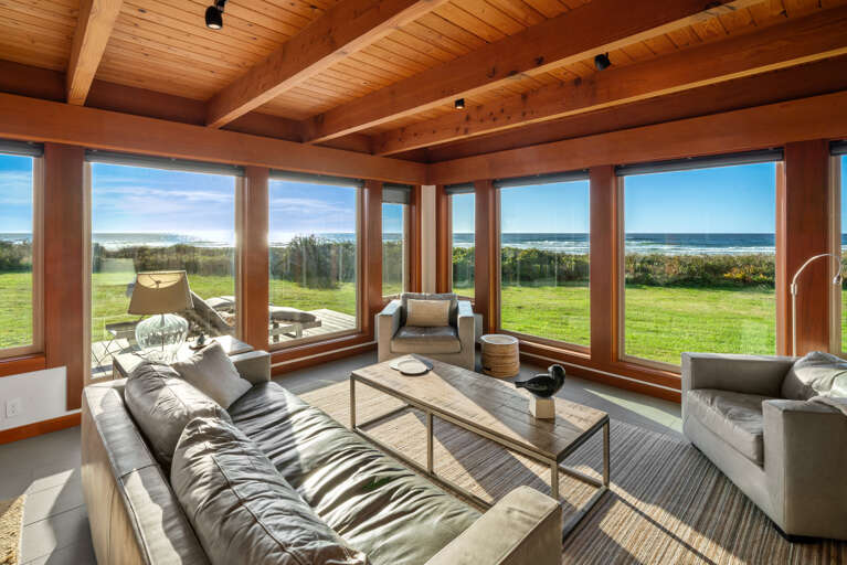 Open living area with smart TV, dining and kitchen area with ocean views.