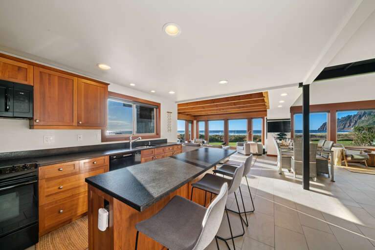 Gourmet Kitchen with breakfast bar open to living area, dining area, and with ocean views
