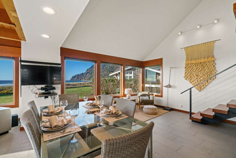 Open living area with smart TV, dining and kitchen area with ocean views.