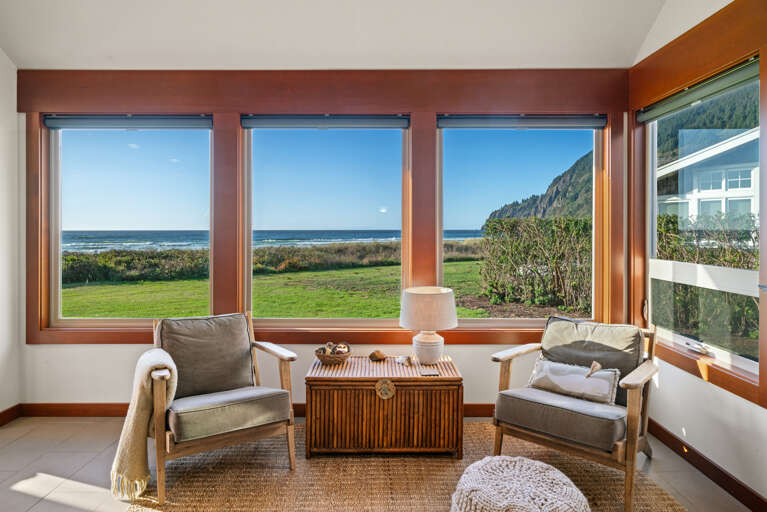 Open living area with smart TV, dining and kitchen area with ocean views.