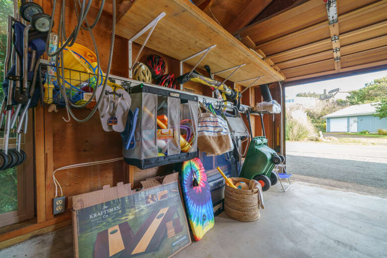 Garage with beach toys, cornhole game, beach wagon, etc
