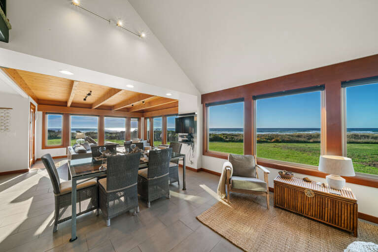 Open living area with smart TV, dining and kitchen area with ocean views.