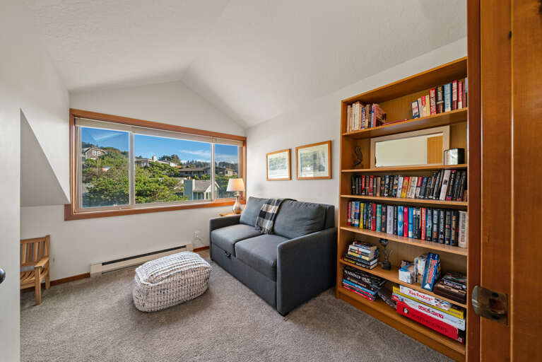 Den room with double hide-a-bed, kids play area, books and games. 