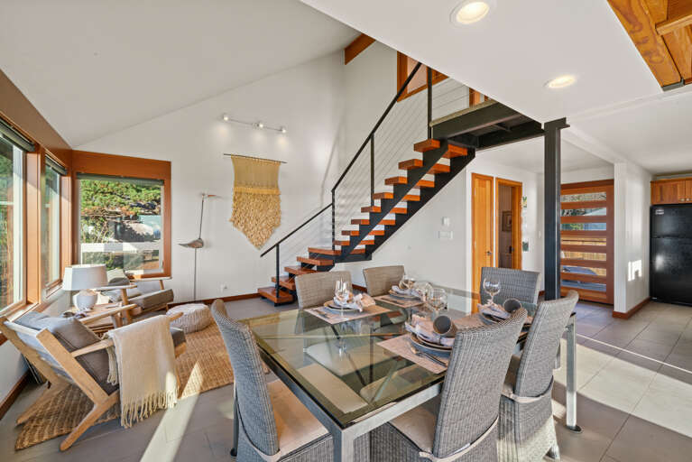 Open living area with smart TV, dining and kitchen area with ocean views.