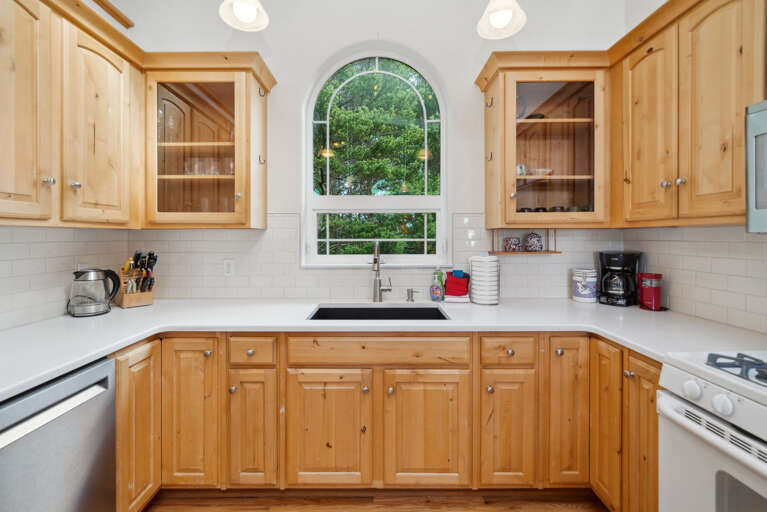 Open living space with,Kitchen with breakfast bar, dining room and  Living room with Gas fireplace, Roku TV, and access to upper deck. 