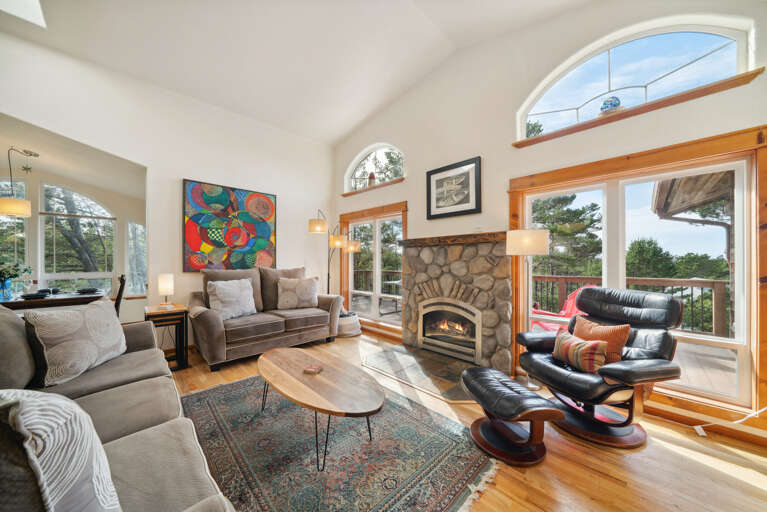 Open living space with, Living room with Gas fireplace, Roku TV, dining room, fully equipped kitchen and access to upper deck. 