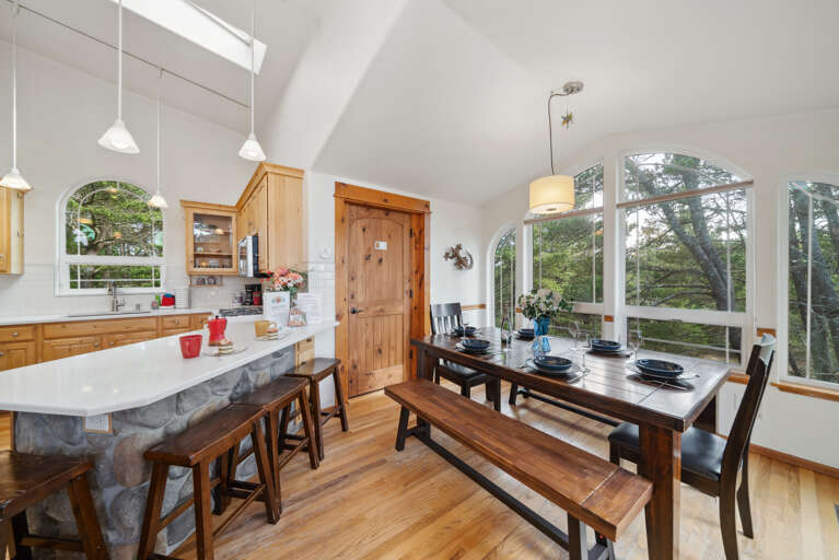 Open living space with,Kitchen with breakfast bar, dining room and  Living room with Gas fireplace, Roku TV, and access to upper deck. 