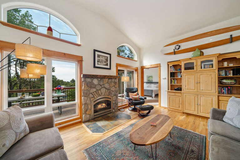 Open living space with, Living room with Gas fireplace, Roku TV, dining room, fully equipped kitchen and access to upper deck. 