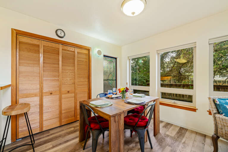 Dining room open to living room with fireplace, TV, queen sofa bed, full bath with walk in shower. 