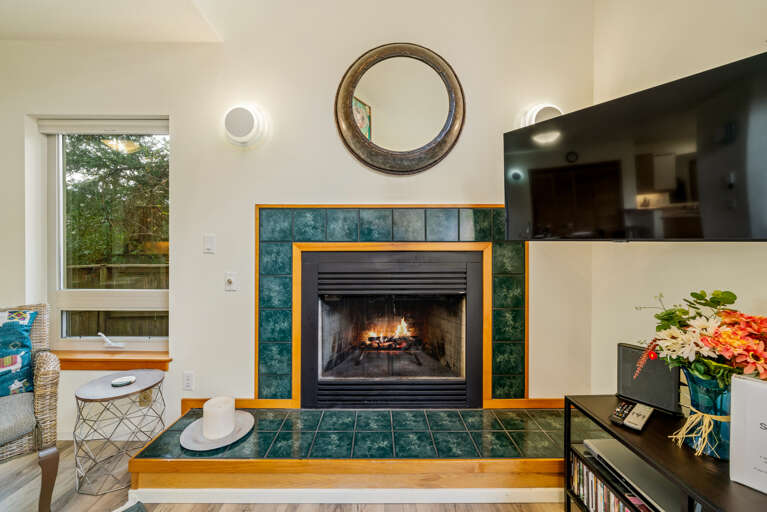 Living room with Gas Fireplace, TV, Queen sofa Sleeper, open to the dining area. 