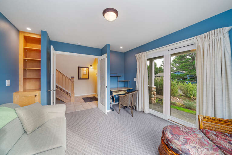 Den with golf course view, desk workspace, Queen sofa sleeper, and lounge chair. 