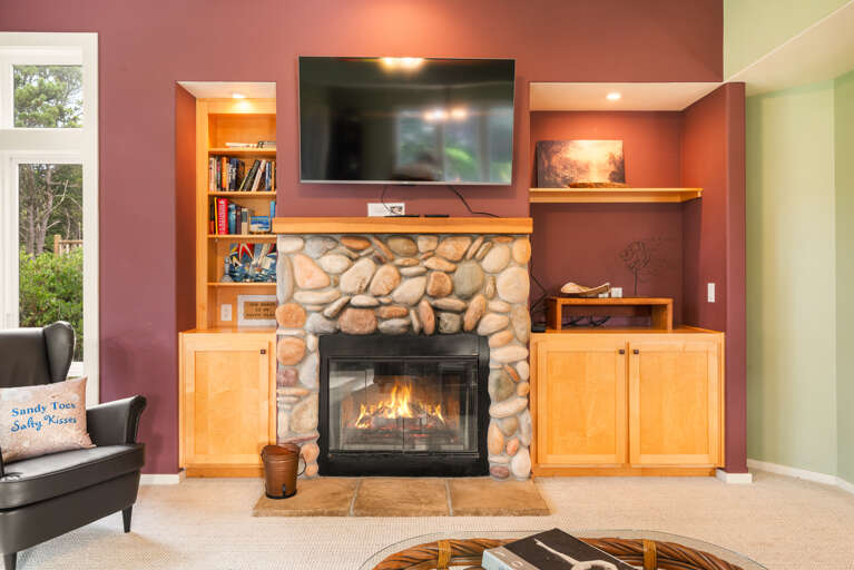 Living room with Smart TV, Wood burning fireplace, and golf course view.