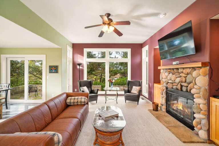 Living room with Smart TV, Wood burning fireplace, and golf course view.