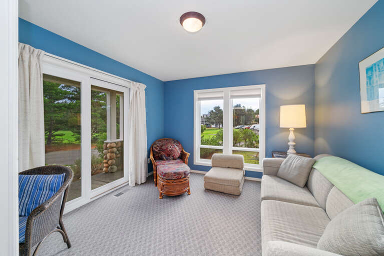 Den with golf course view, desk workspace, Queen sofa sleeper, and lounge chair. 