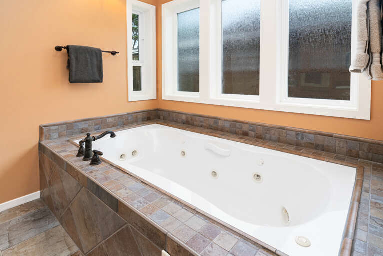 Master bath with jacuzzi tub, walk in shower, large walk in closet and double sinks. 