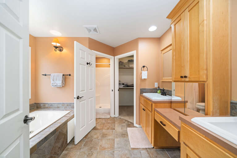 Master bath with jacuzzi tub, walk in shower, large walk in closet and double sinks. 