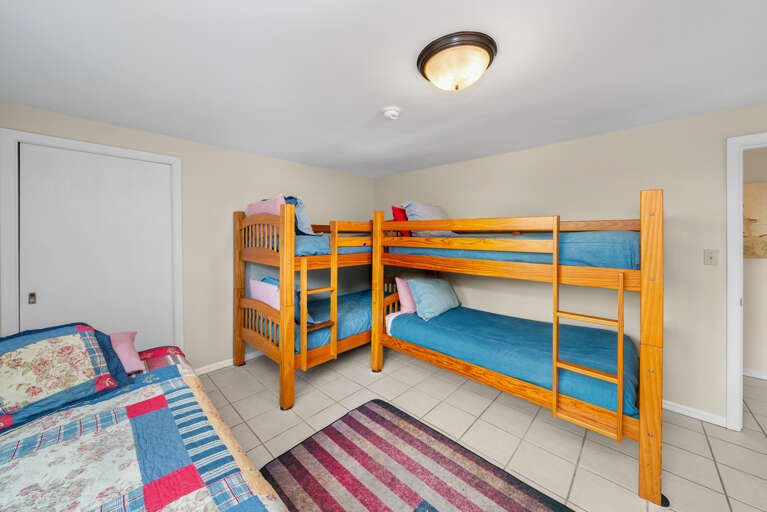 Bunk room with two sets of bunks and two twin beds.  Bunk room with two sets of bunks and two twin beds.