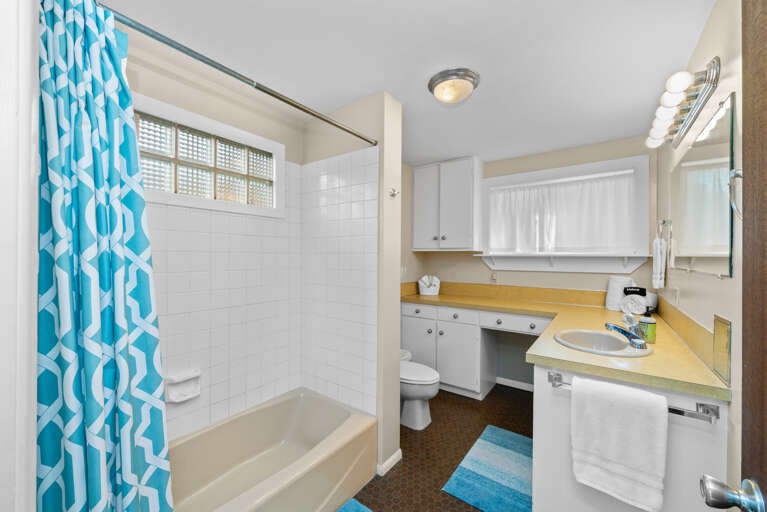 Second main floor bathroom with tub shower combo.  Second main floor bathroom with tub shower combo.