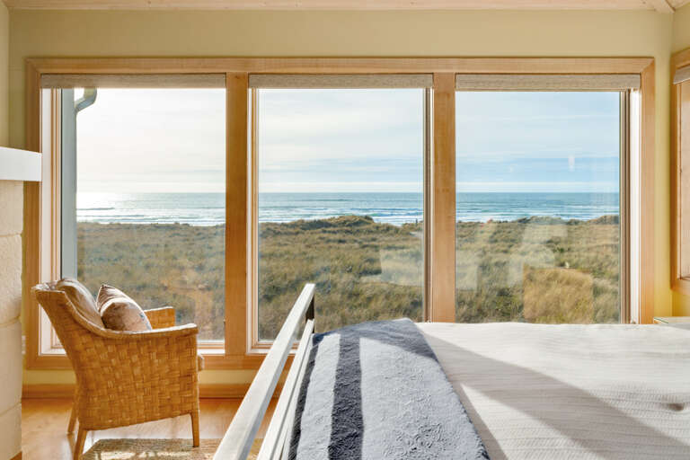 Master bedroom with ocean view, desk work space, gas fireplace, king bed, sitting chair, and TV with Direct TV and streaming.  Master bedroom with ocean view, desk work space, gas fireplace, king bed, sitting chair, and TV with Direct TV and streaming.