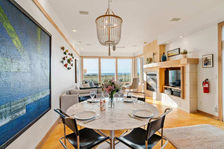 Ocean view dining room open to living room with gas fireplace, Dish and streaming TV, French doors to outside.  Ocean view dining room open to living room with gas fireplace, Dish and streaming TV, French doors to outside.