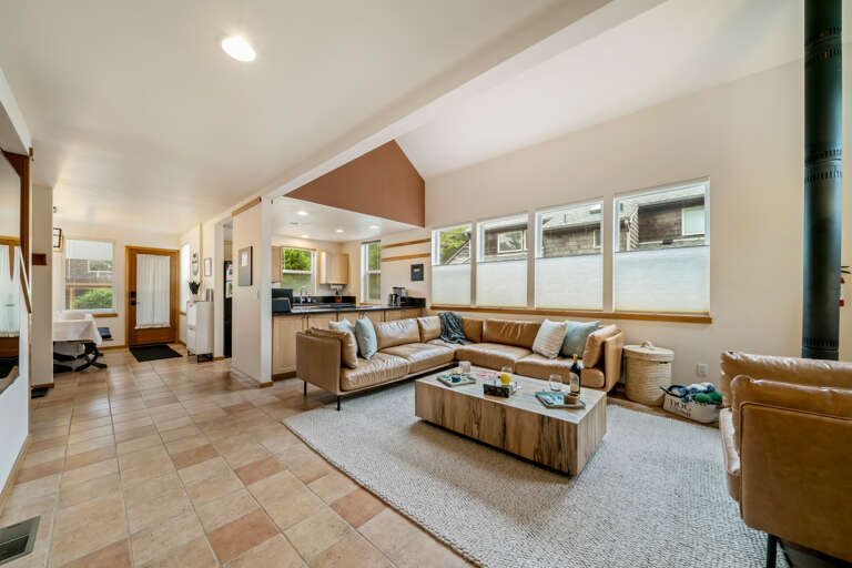 Living room with comfy sectional couch and wood stove and large big screen TV
