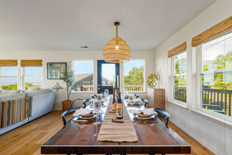 Large dining space and access to the ocean view deck with outdoor seating. 