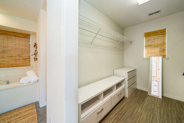 walk in closet in the master bedroom bath with jacuzzi tub and walk in shower.