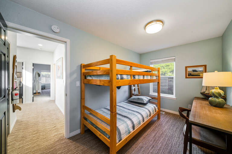 3rd lower bedroom with a set of bunk beds and office desk. Access to garage through this room. 
