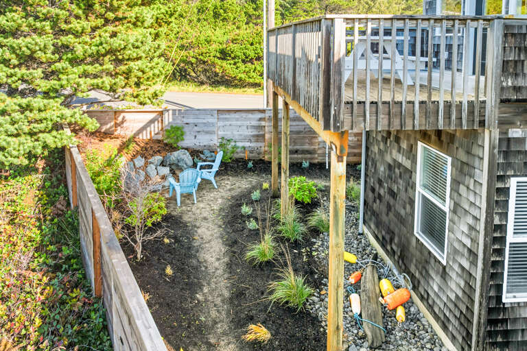Deck off of dining room, fenced back yard with firepit and outdoor shower. 