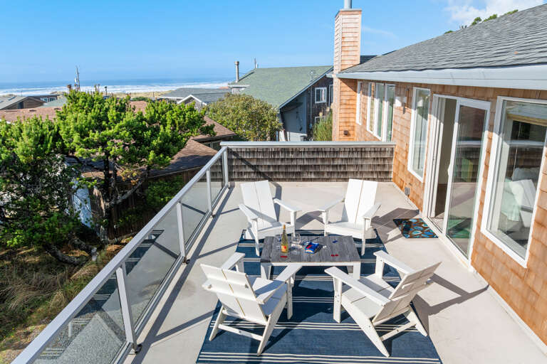 Master bedroom deck with Ocean view, wind blocking panels, lounge chairs.