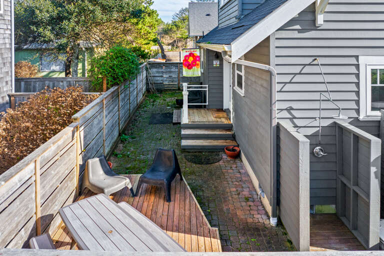 Back yard area for BBQing, outdoor dining and outdoor shower. 