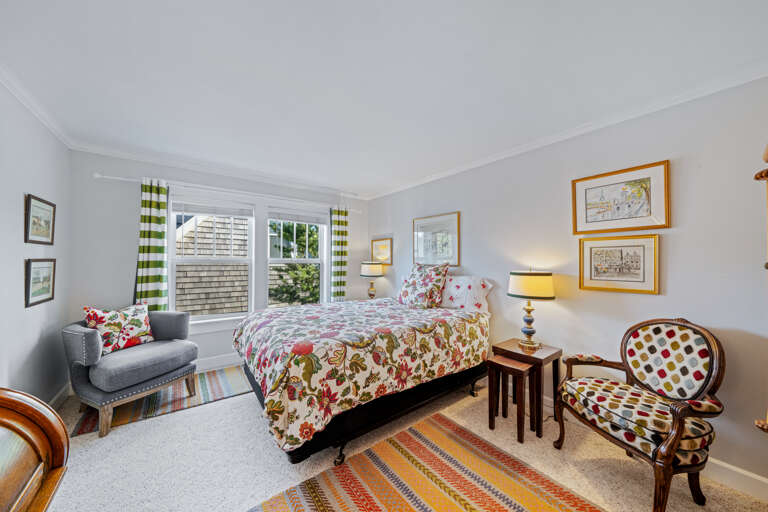 3rd queen upstairs bedroom with streaming TV and relaxing chair and desk 