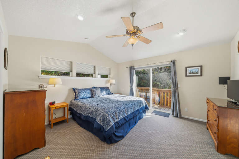 Master bedroom with king bed, access to the wrap around deck. Master bath attached with jacuzzi tub and walk in shower. 